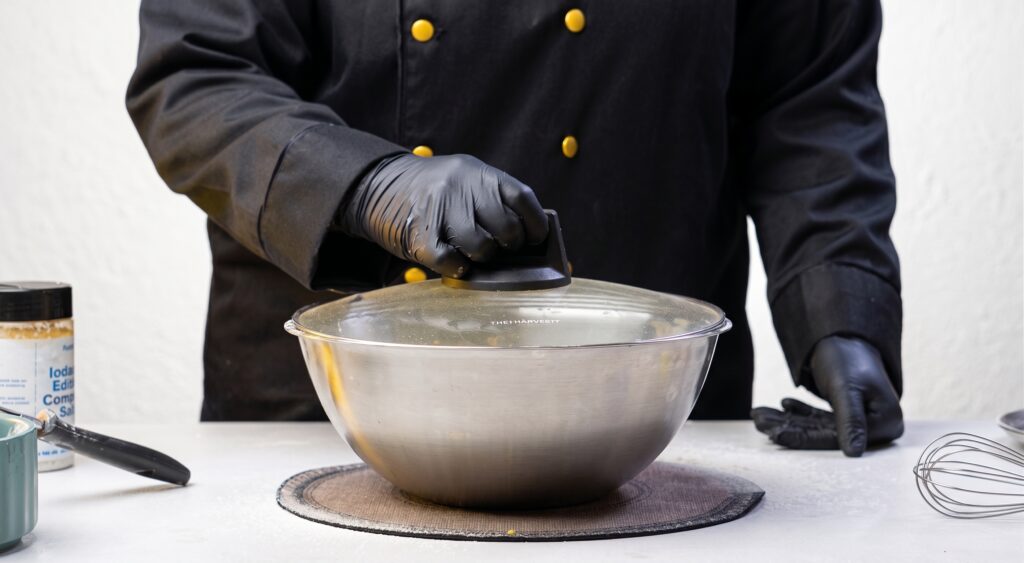 Nylon Khaman dhokla Bowl of prepared khaman dhokla batter covered and resting before steaming