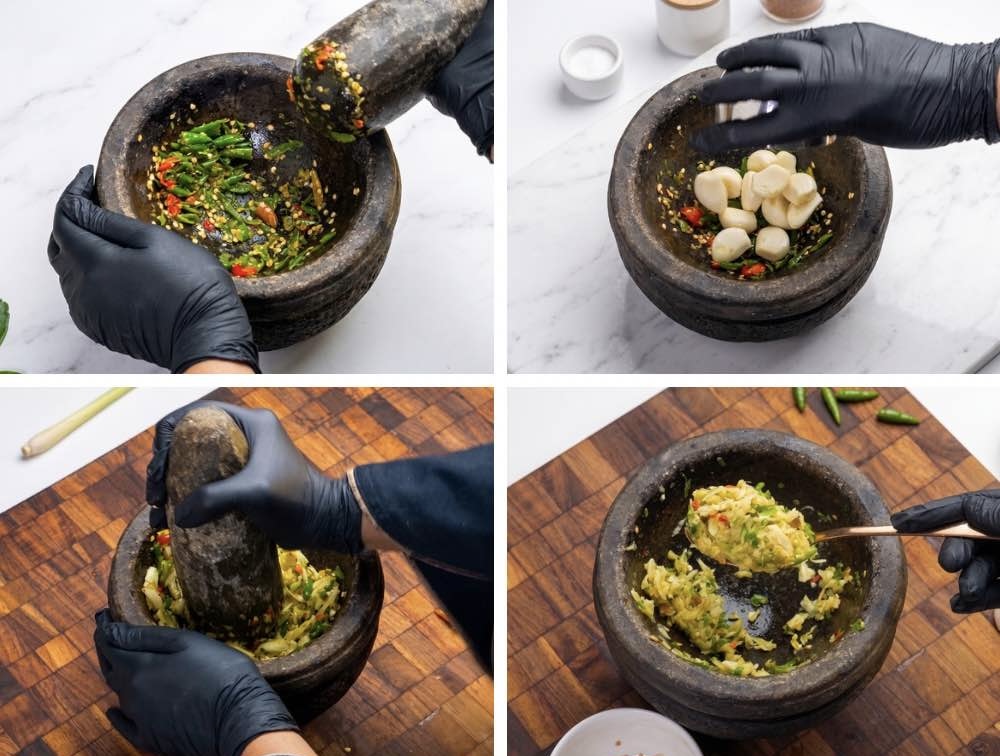 Crushing Garlic and Bird’s Eye Chilies Crushed bird’s eye chilies and garlic in a mortar and pestle for Thai basil beef