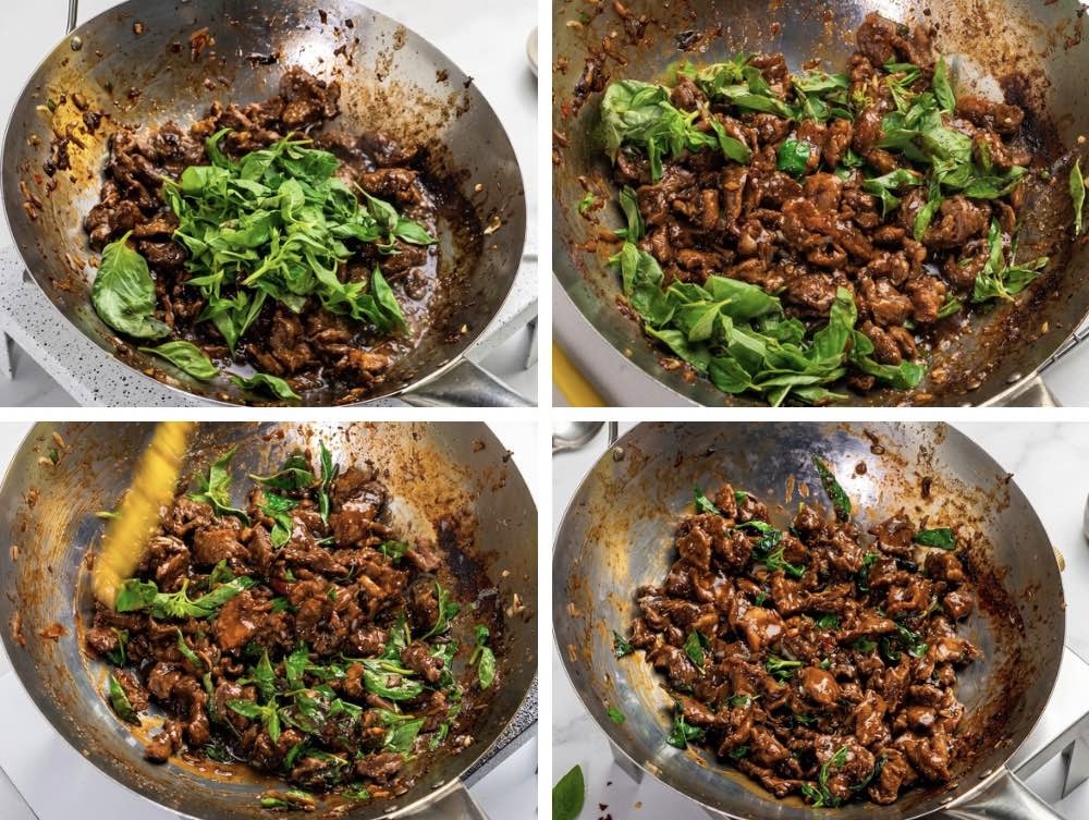 Adding Fresh Holy Basil Fresh holy basil leaves tossed with spicy beef in a wok