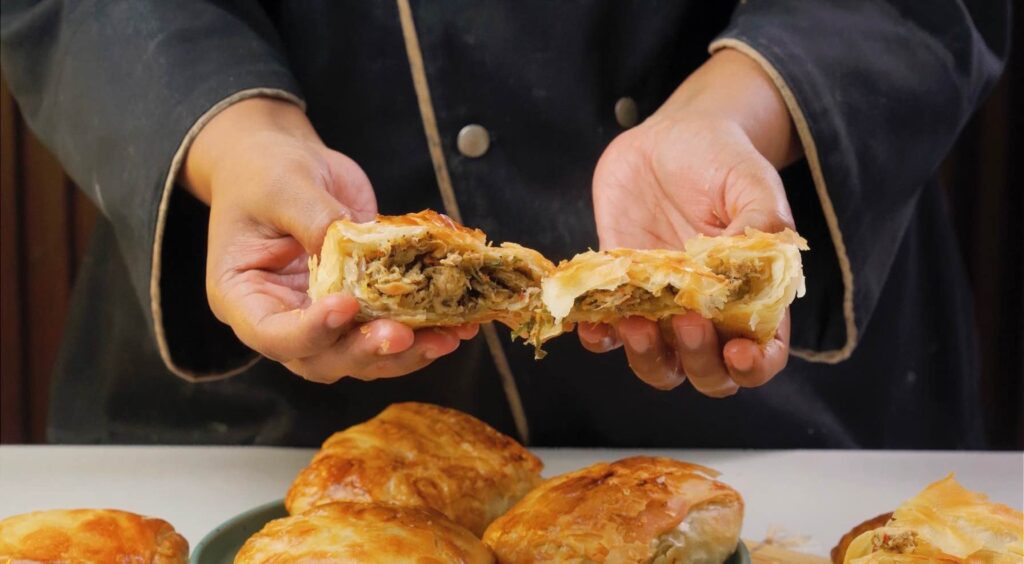Turkish borek Freshly baked flaky chicken Turkish börek sliced to show crispy layers