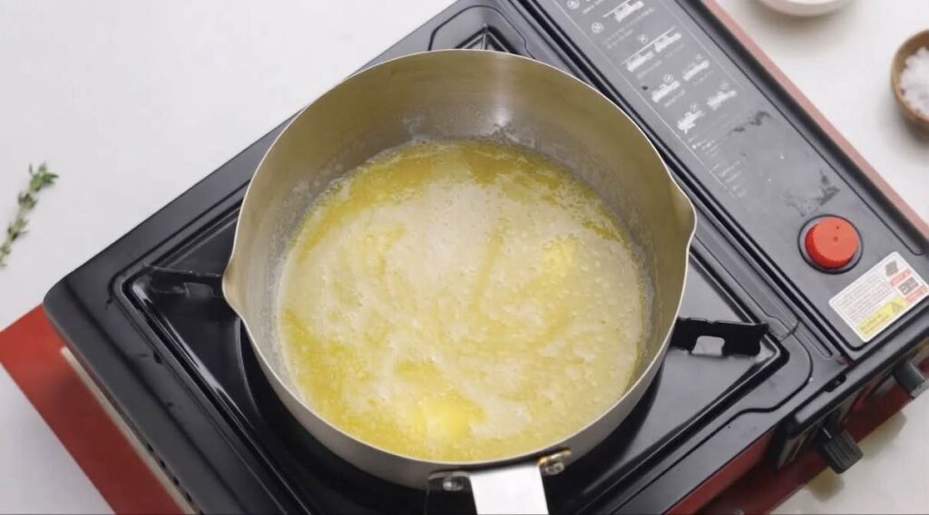 Turkish borek Melted butter and oil combined in a small bowl to create the flaky pastry layering mixture