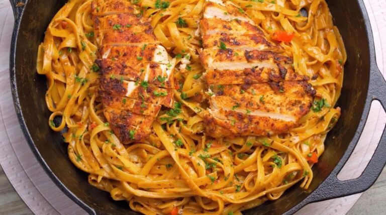 Creamy Cajun chicken fettuccine pasta topped with sliced Cajun chicken and fresh parsley**