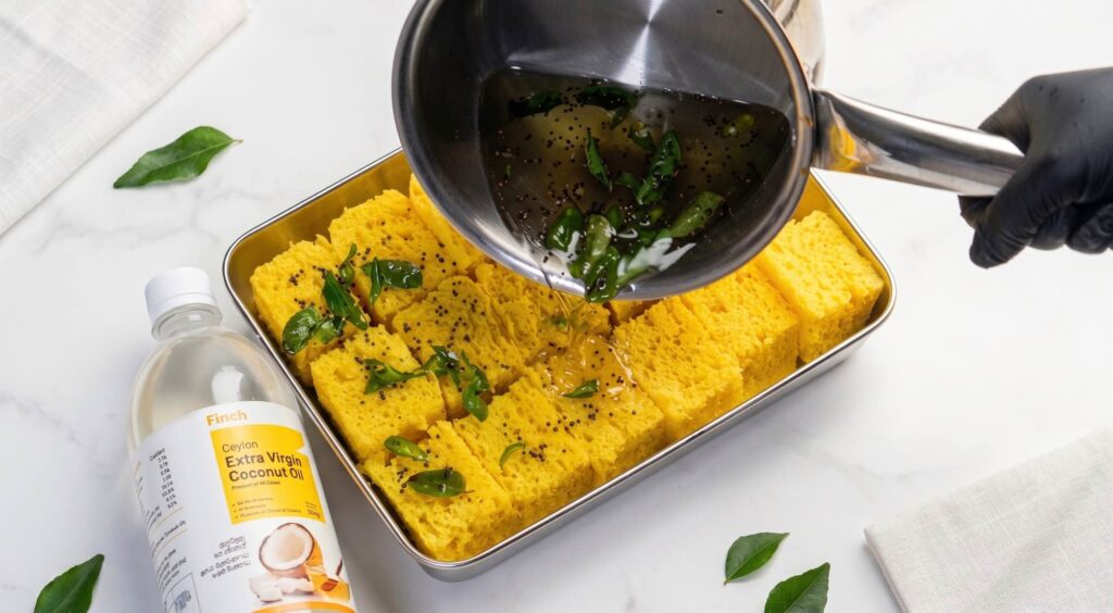 Nylon Khaman Dhokla Warm sweet and savoury tempering being poured over freshly cut khaman dhokla Garnishing Image