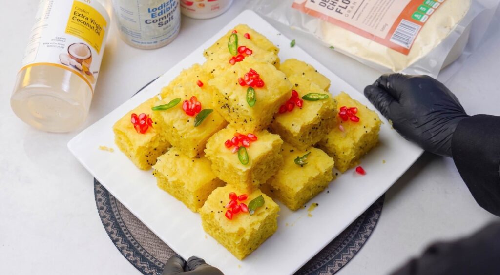 Nylon Khaman Dhokla Soft spongy Nylon Khaman Dhokla garnished with pomegranate arils and served with green chutney
