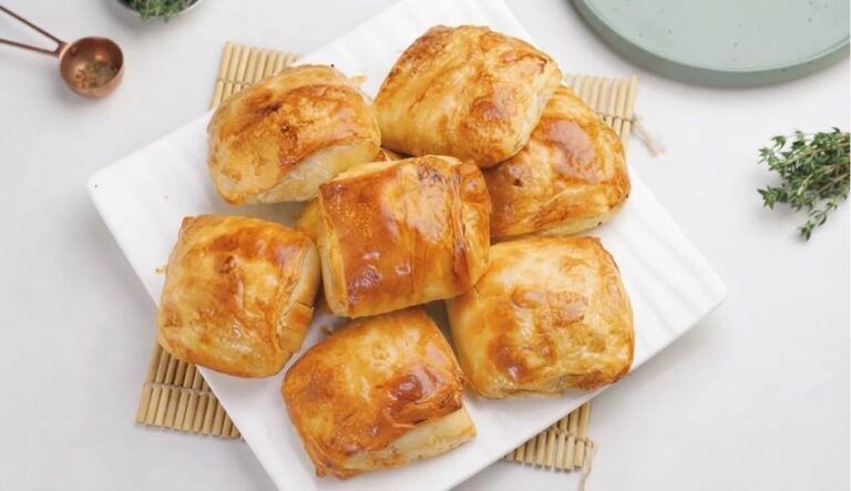 Crispy golden-brown chicken and leek Turkish börek rolls served on a serving platter